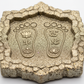 Maa Lakshmi Charan Paduka on Pyrite Frame macro close-up of sacred footprint design on white background