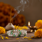 Dhan Yog Bracelet in a serene spiritual setting with diya and marigolds