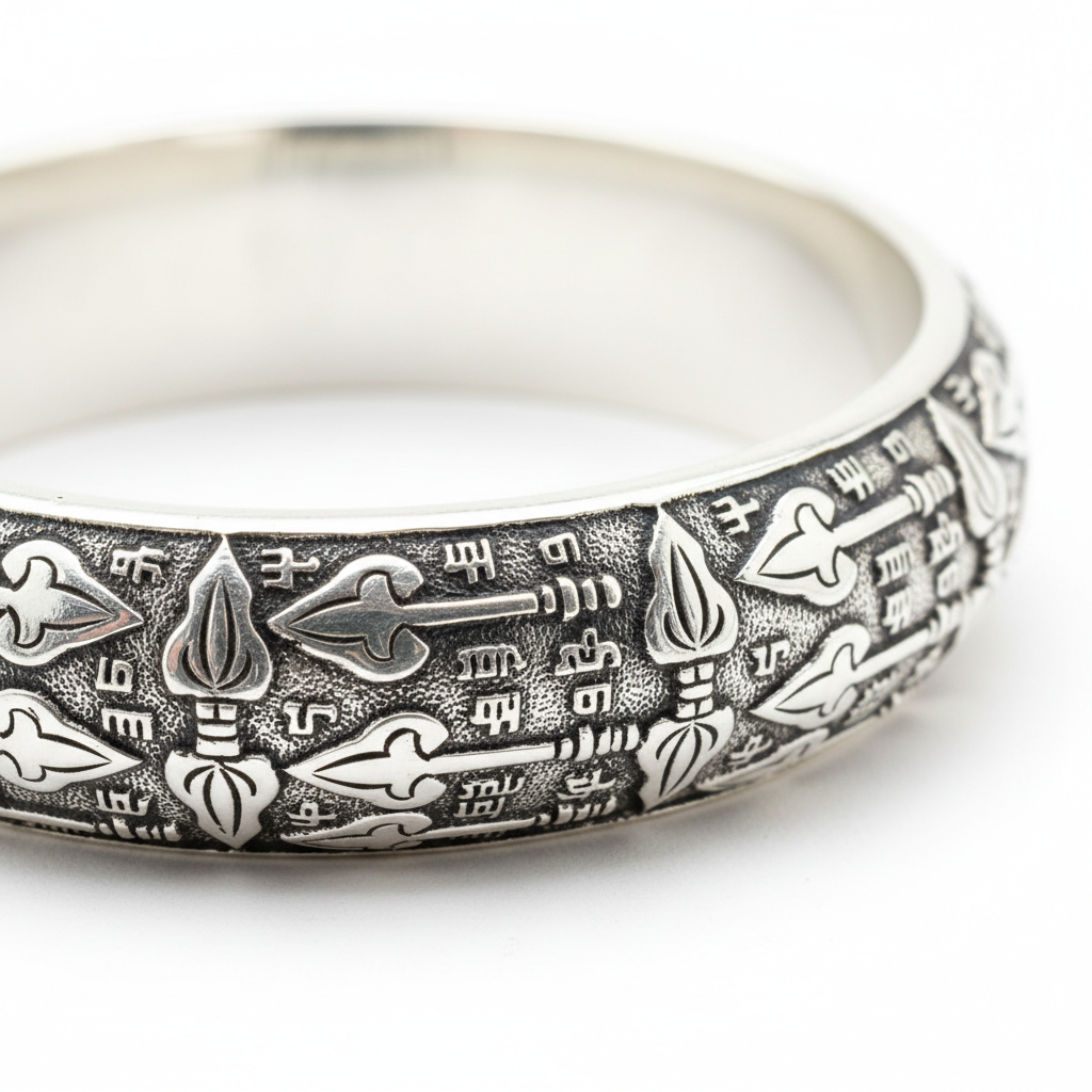 Silver Vel Kada macro detail showing intricate Vel divine spear motif and polished silver surface
