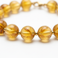 Citrine Bracelet close-up of golden yellow citrine beads on white background