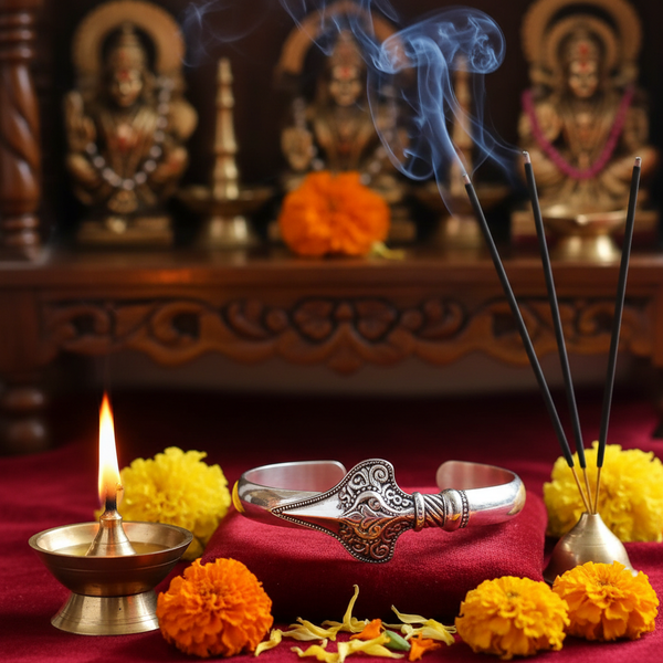 Silver Vel Kada bracelet of Lord Murugan in a spiritual Indian setting with diya, flowers and incense