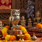 Pyrite owl figurine in a spiritual Indian setting with diya, flowers and incense