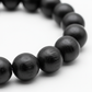 Stretchable Karungali Mala 8mm macro close-up of smooth black ebony bead texture on white background