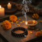 Black Tourmaline Bracelet in a spiritual Indian setting with diya, marigold flowers and incense