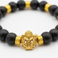 7mm Golden Capped Karungali Mala macro close-up showing black ebony bead texture, golden cap detail and Hanuman pendant craftsmanship
