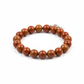 Red jasper bracelet full shot on white background showing warm earthy brick-red beads