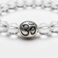 Wealth OM Bracelet macro close-up showing engraved OM symbol bead and crystal bead texture