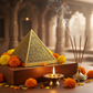 Siddh Lakshmi Yantra Pyramid in a spiritual Indian setting with diya, flowers and incense