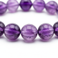 Amethyst Bracelet close-up of violet amethyst beads on white background